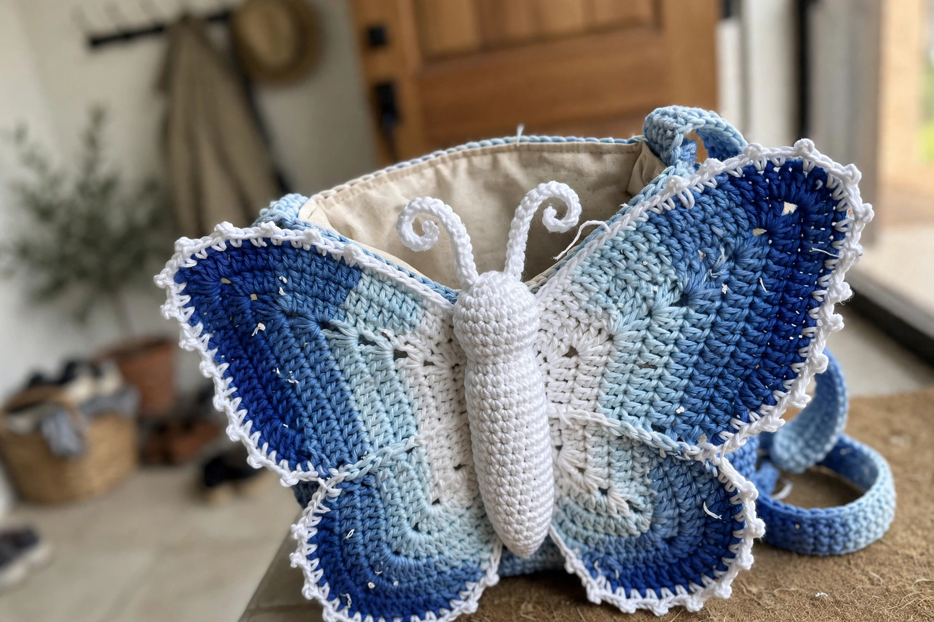 Close-up of the blue ombre wings, scalloped border and body tube on the Blue Monarch Butterfly Bag