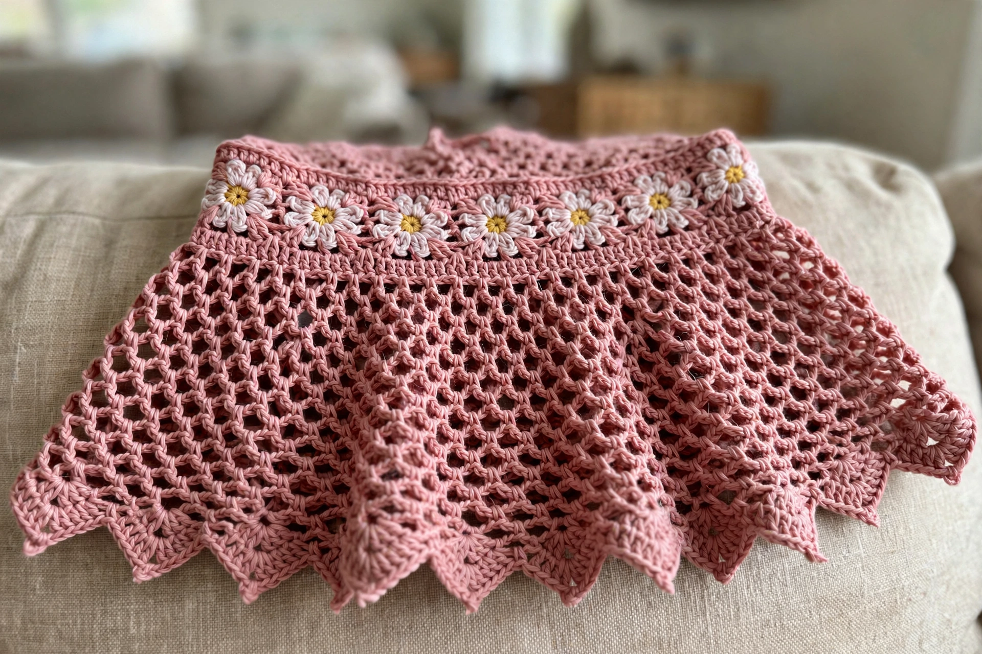 Close-up of the daisy motif waistband and mesh peplum on the dusty rose fairy top