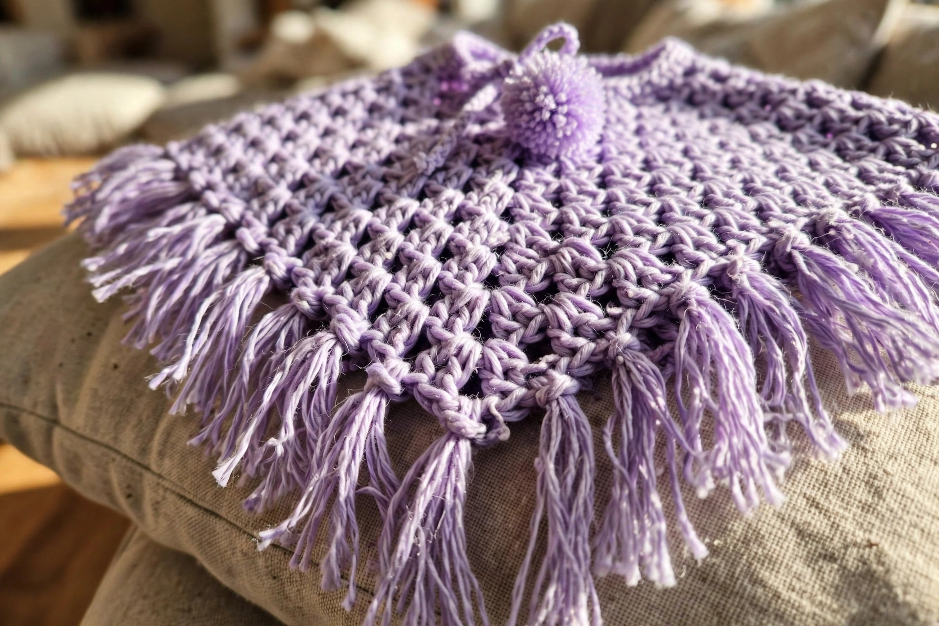 Close-up of the lavender granny cluster texture, fringe and pom pom tie