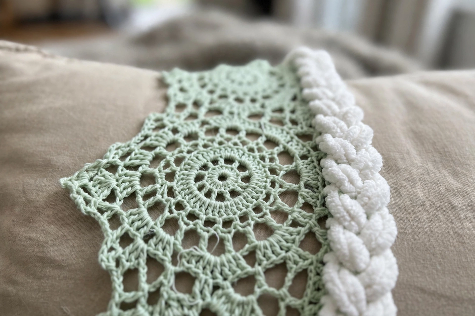 Close-up of the mint lace and fluffy white spine braid on the luna moth poncho