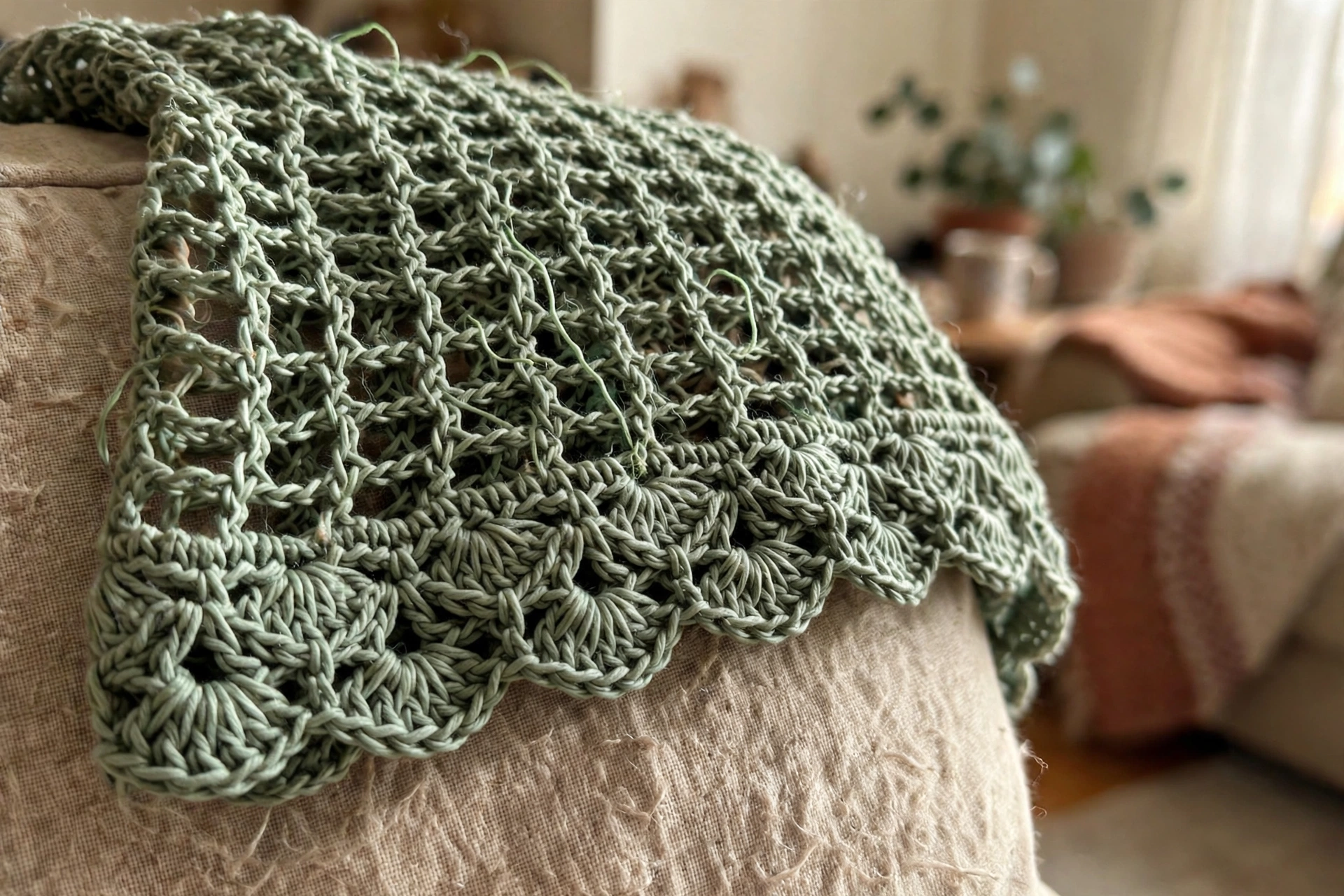 Close-up of the shell stitch waist motif and mesh texture on the sage green fairy top