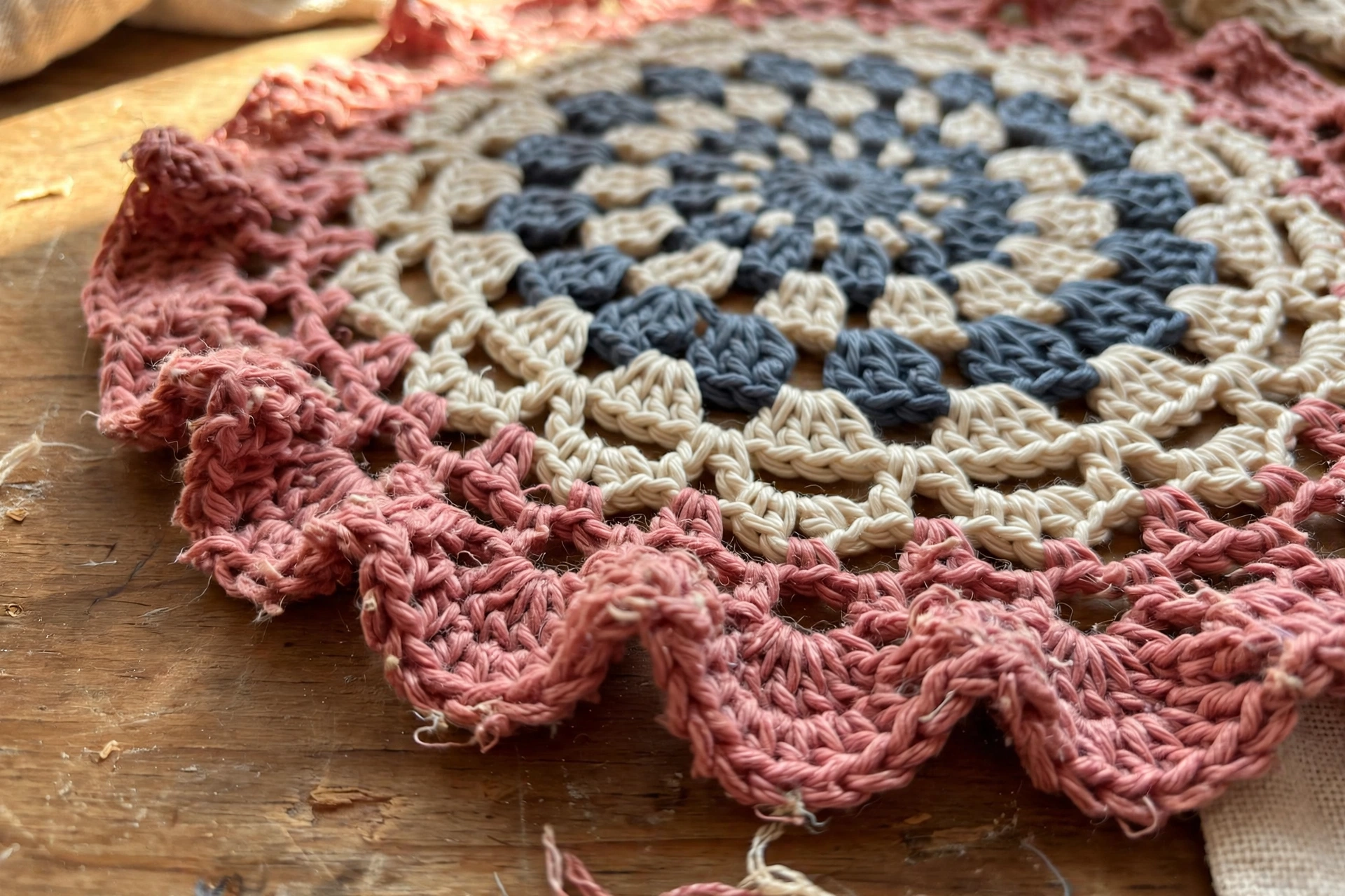 Close-up of the dusty rose ruffled border of the carnation doily